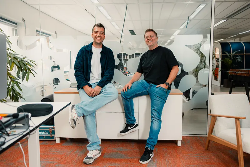 Two colleagues taking a break on the cabinet